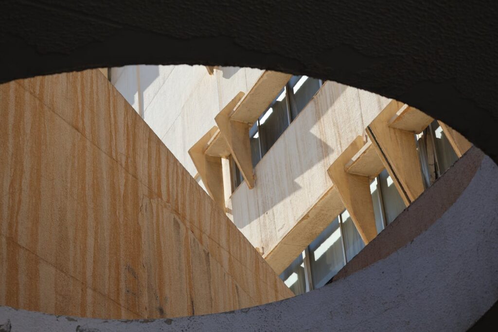 Captivating view of modern architecture through a circular opening in Damascus, Syria.